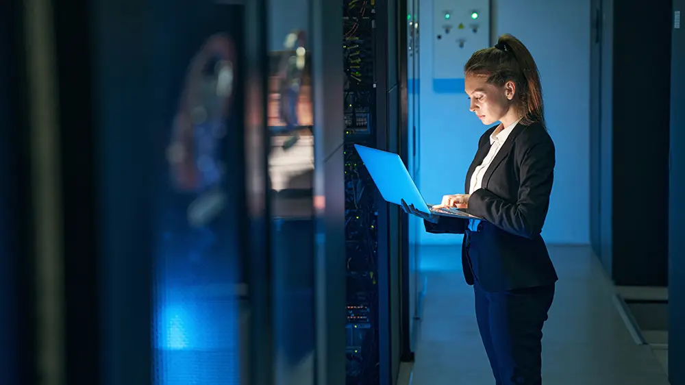 Female engineering working on a security assessment at a data center