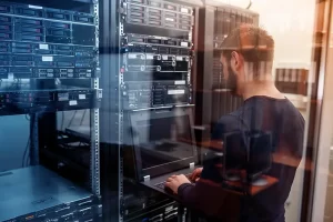 Specialist working on network design in a server room